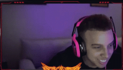 A Man Wearing Red Headphones Is Sitting In Front Of A Computer Monitor . GIF