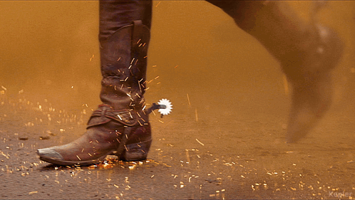 A Man Wearing Red Leather Pants Has A Gun Holster On His Belt GIF