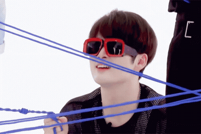 A Man Wearing Red Sunglasses Is Surrounded By Blue Rope GIF