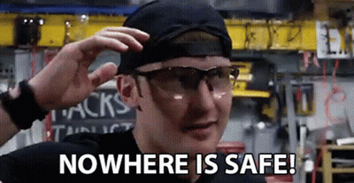 A Man Wearing Safety Glasses And A Hat Is Saying `` Nowhere Is Safe ! '' GIF