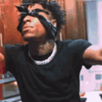 A Man Wearing Sunglasses And A Bandana On His Head Is Standing In Front Of A Mirror . GIF