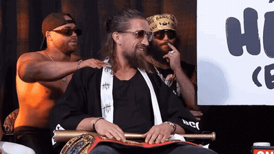 A Man Wearing Sunglasses And A Bandana That Says Gang Bang GIF