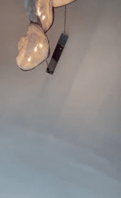 A Man Wearing Sunglasses And A Baseball Cap Is Standing In A Room . GIF
