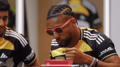 A Man Wearing Sunglasses And A Black And Yellow Shirt With The Number 19 On The Front GIF