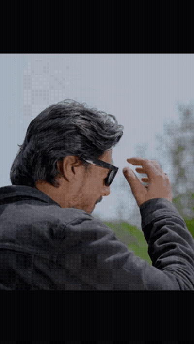 A Man Wearing Sunglasses And A Black Jacket Adjusts His Glasses GIF