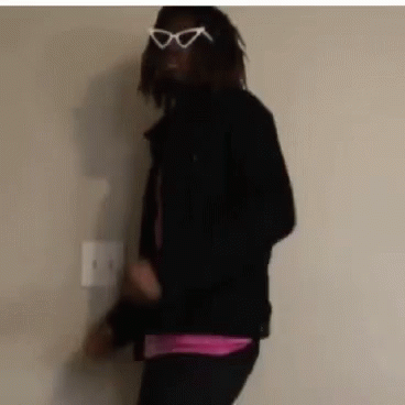 A Man Wearing Sunglasses And A Black Jacket Is Dancing . GIF