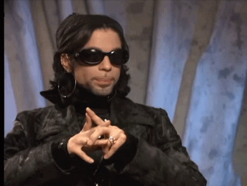 A Man Wearing Sunglasses And A Black Jacket Is Making A Peace Sign With His Hands GIF