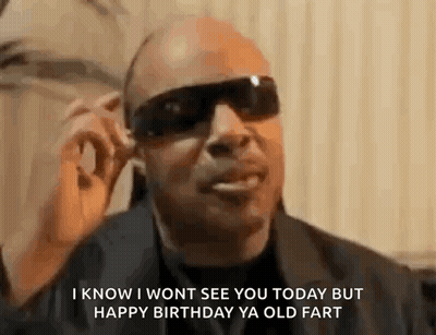 A Man Wearing Sunglasses And A Black Jacket Is Talking On A Cell Phone . GIF