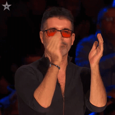 A Man Wearing Sunglasses And A Black Shirt Is Clapping His Hands GIF