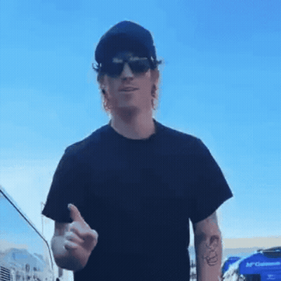 A Man Wearing Sunglasses And A Black Shirt Is Giving A Thumbs Up GIF