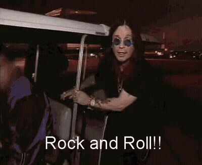 A Man Wearing Sunglasses And A Black Shirt Is Saying Rock And Roll GIF