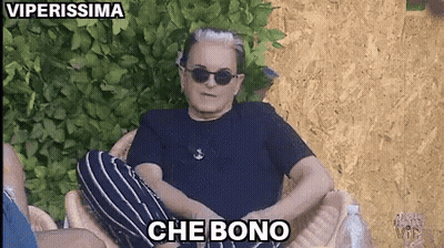 A Man Wearing Sunglasses And A Black Shirt Is Sitting In A Chair With The Words Che Bono Above Him GIF
