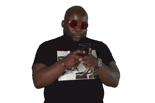 A Man Wearing Sunglasses And A Black Shirt Is Using A Cell Phone Sticker