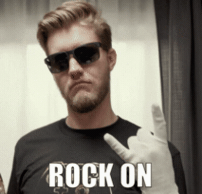 A Man Wearing Sunglasses And A Black Shirt With The Word Rock On On It GIF