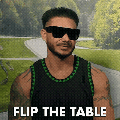 A Man Wearing Sunglasses And A Black Tank Top With The Words Flip The Table On The Bottom GIF