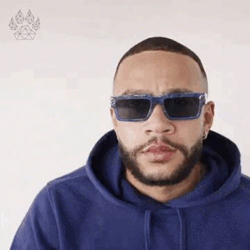A Man Wearing Sunglasses And A Blue Hoodie Is Making A Funny Face . GIF
