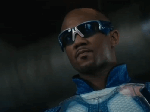 A Man Wearing Sunglasses And A Blue Jacket Is Looking Up GIF