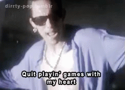 A Man Wearing Sunglasses And A Blue Shirt Is Dancing And Singing . GIF