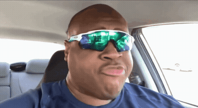 A Man Wearing Sunglasses And A Blue Shirt Making A Funny Face GIF
