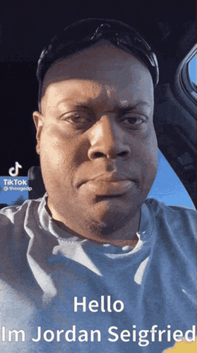 A Man Wearing Sunglasses And A Blue Shirt Says Hello Im Jordan Seigfried GIF