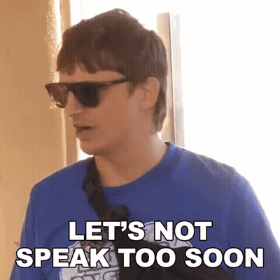A Man Wearing Sunglasses And A Blue Shirt With The Words Let 'S Not Speak Too Soon GIF