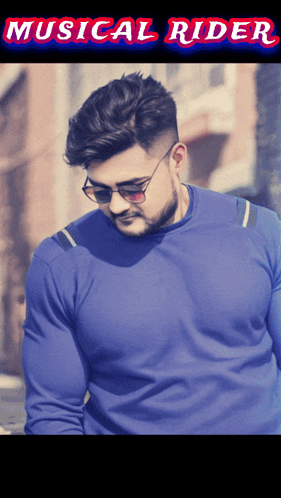 A Man Wearing Sunglasses And A Blue Sweater With The Words Musical Rider On The Bottom GIF