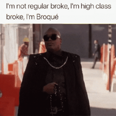 A Man Wearing Sunglasses And A Cape Is Walking Down A Street With The Caption I 'M Not Regular Broke GIF