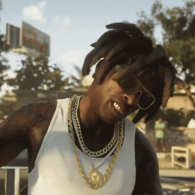 A Man Wearing Sunglasses And A Chain Around His Neck Is Smiling GIF