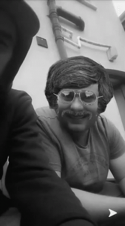 A Man Wearing Sunglasses And A Fake Mustache Is Smiling GIF