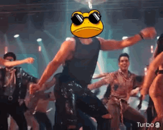 A Man Wearing Sunglasses And A Frog Face Is Dancing In A Club . GIF