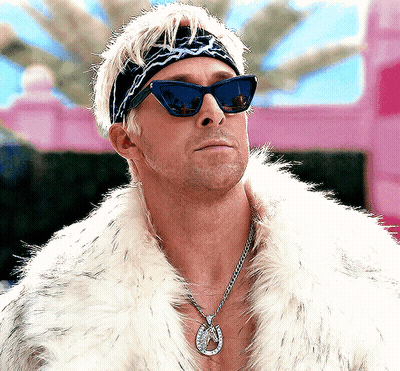 A Man Wearing Sunglasses And A Fur Coat Has A Horseshoe Pendant Around His Neck GIF
