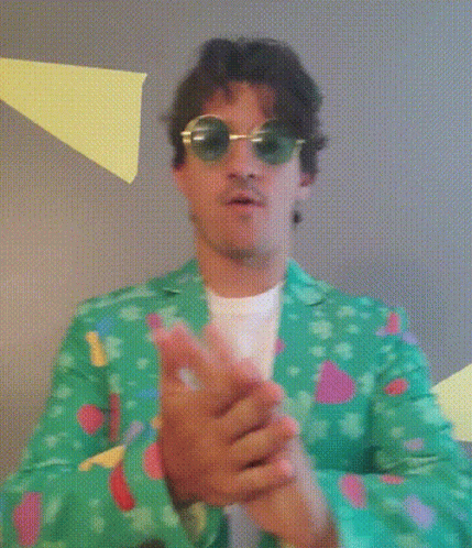 A Man Wearing Sunglasses And A Green Jacket Is Making A Stop Sign With His Hands GIF