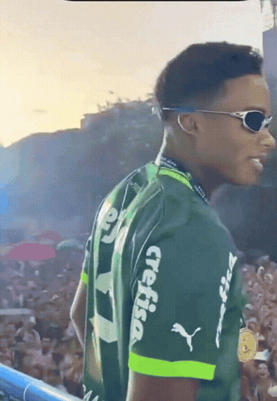 A Man Wearing Sunglasses And A Green Shirt With Crefisa On The Sleeves GIF