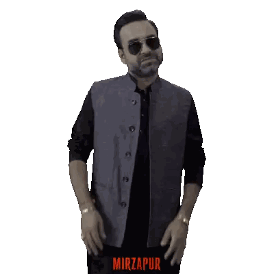 A Man Wearing Sunglasses And A Grey Vest With The Word Mirzapur On The Bottom Right Sticker