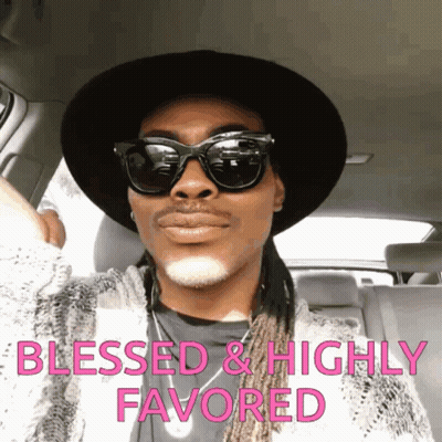 A Man Wearing Sunglasses And A Hat Is Sitting In A Car With The Words Blessed And Highly Favored Written Above Him GIF