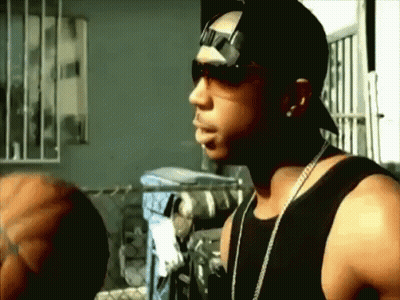 A Man Wearing Sunglasses And A Hat Is Standing In A Room GIF
