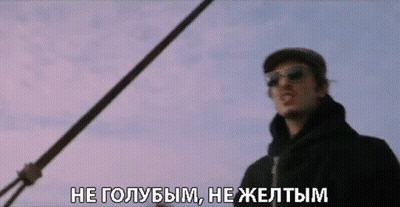 A Man Wearing Sunglasses And A Hat Is Standing In Front Of A Purple Sky GIF
