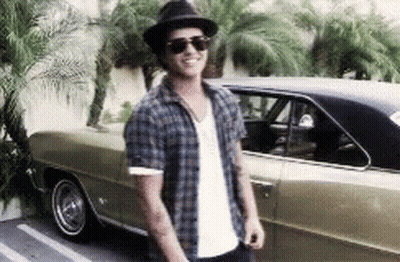 A Man Wearing Sunglasses And A Hat Is Standing Next To A Car GIF
