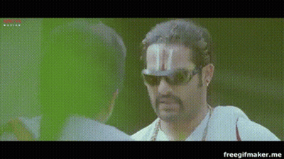 A Man Wearing Sunglasses And A Hat With A T On It GIF