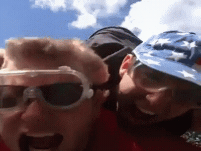 A Man Wearing Sunglasses And A Hat With Stars On It Looks At The Camera GIF