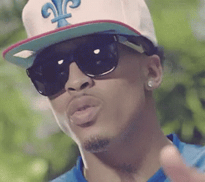 A Man Wearing Sunglasses And A Hat With The Letter G On It GIF