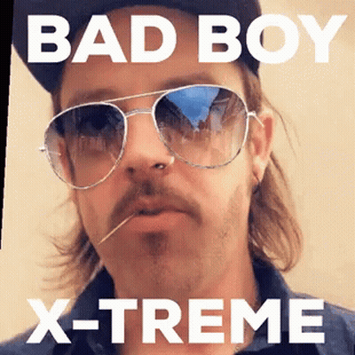 A Man Wearing Sunglasses And A Hat With The Words Bad Boy X-Treme GIF
