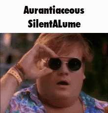 A Man Wearing Sunglasses And A Hawaiian Shirt Is Looking Through His Glasses . GIF