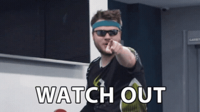 A Man Wearing Sunglasses And A Headband Points At The Camera With The Words Watch Out Written Below Him GIF