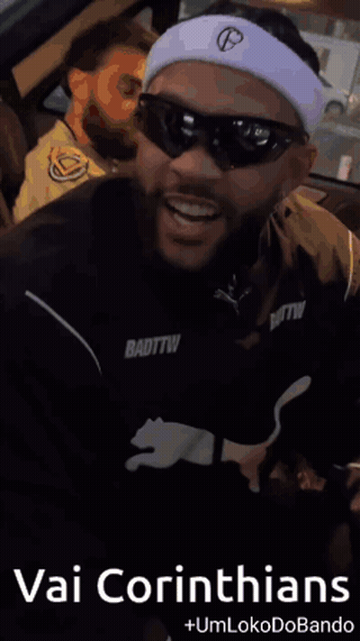 A Man Wearing Sunglasses And A Headband With The Words Vai Corinthians On It GIF