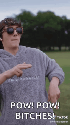 A Man Wearing Sunglasses And A Hoodie Says Pow Pow Bitches On A Tiktok Video . GIF