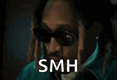A Man Wearing Sunglasses And A Jacket Is Standing In Front Of A Door With The Word Smh Written On It . GIF