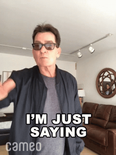 A Man Wearing Sunglasses And A Jacket Says I 'M Just Saying In A Living Room . GIF