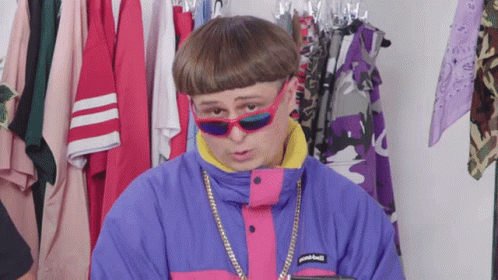 A Man Wearing Sunglasses And A Jacket That Says Patagonia On The Front GIF