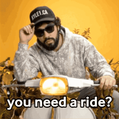A Man Wearing Sunglasses And A Kyle1.ca Hat Rides A Scooter GIF